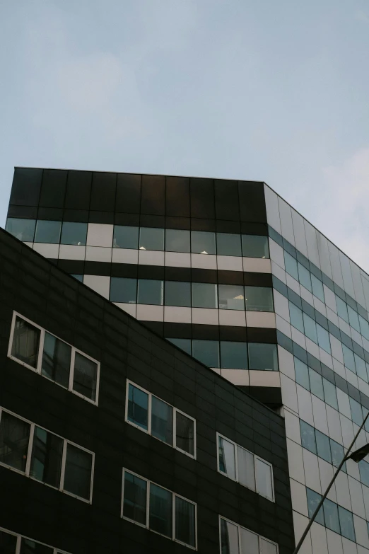 a couple of buildings that are next to each other, unsplash, modernism, low quality photo, office building, espoo, black windows