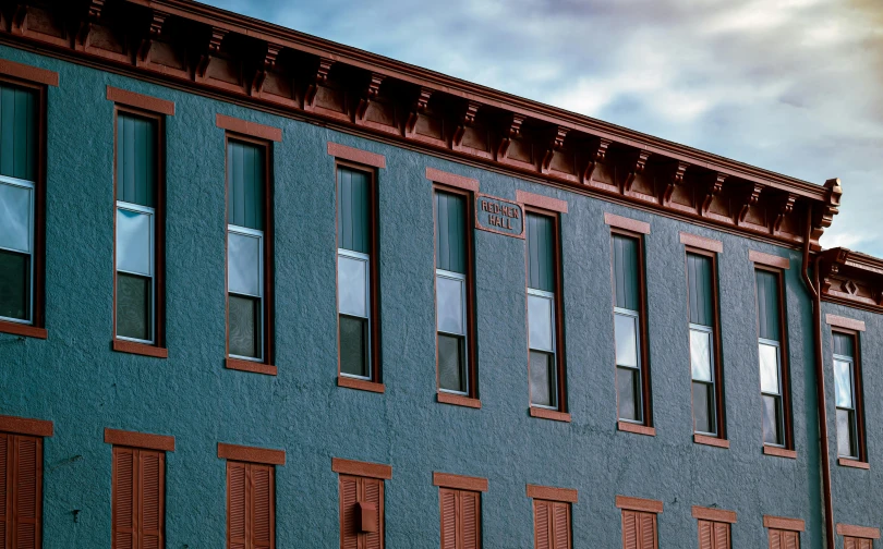 a red fire hydrant sitting in front of a blue building, inspired by Edward Hopper, pexels contest winner, heidelberg school, black windows, teal orange, pueblo architecture, walton's five and dime