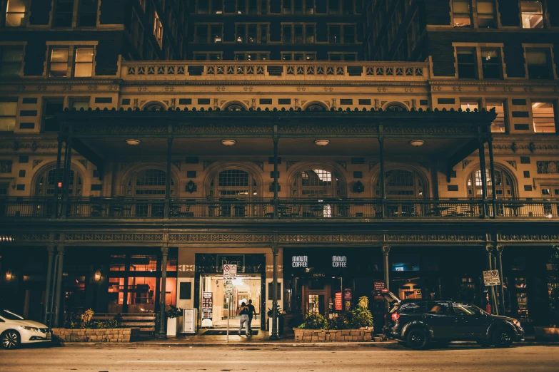a couple of cars that are parked in front of a building, by Austin English, pexels contest winner, australian tonalism, taverns nighttime lifestyle, downtown, moody : : wes anderson, ornate intricate