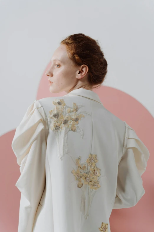 a woman standing in front of a pink circle, inspired by Josefina Tanganelli Plana, renaissance, ornate back tuxedo, off - white collection, embroidered shirt, ivory and copper