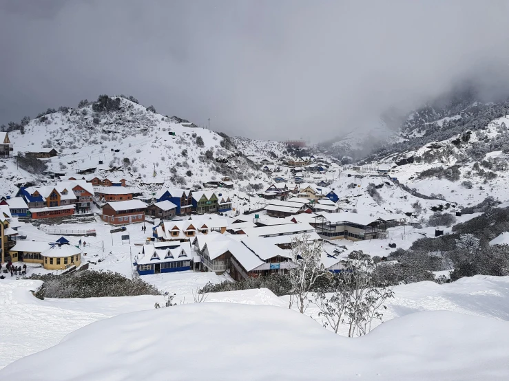 a group of people riding skis down a snow covered slope, villages, neo - andean architecture, profile image