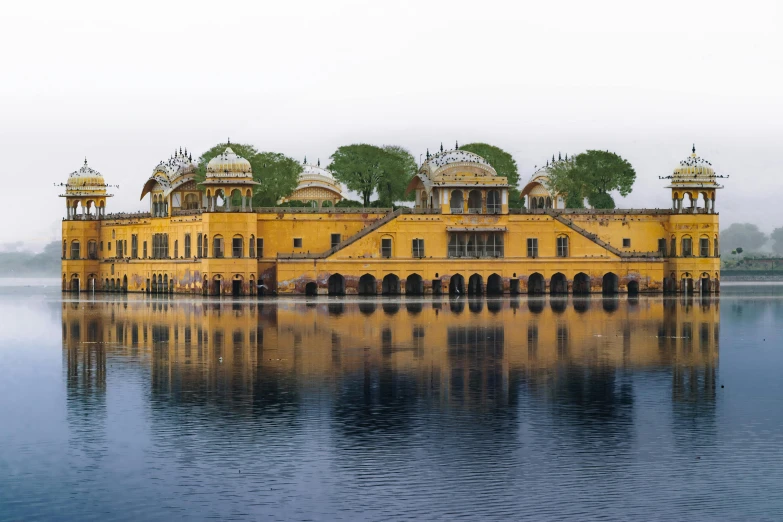 a large yellow building sitting on top of a lake, a digital rendering, pexels contest winner, renaissance, india, panoramic, fan favorite, architectural photograph