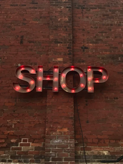 a sign that is on the side of a building, the store, uplit, profile image, society 6
