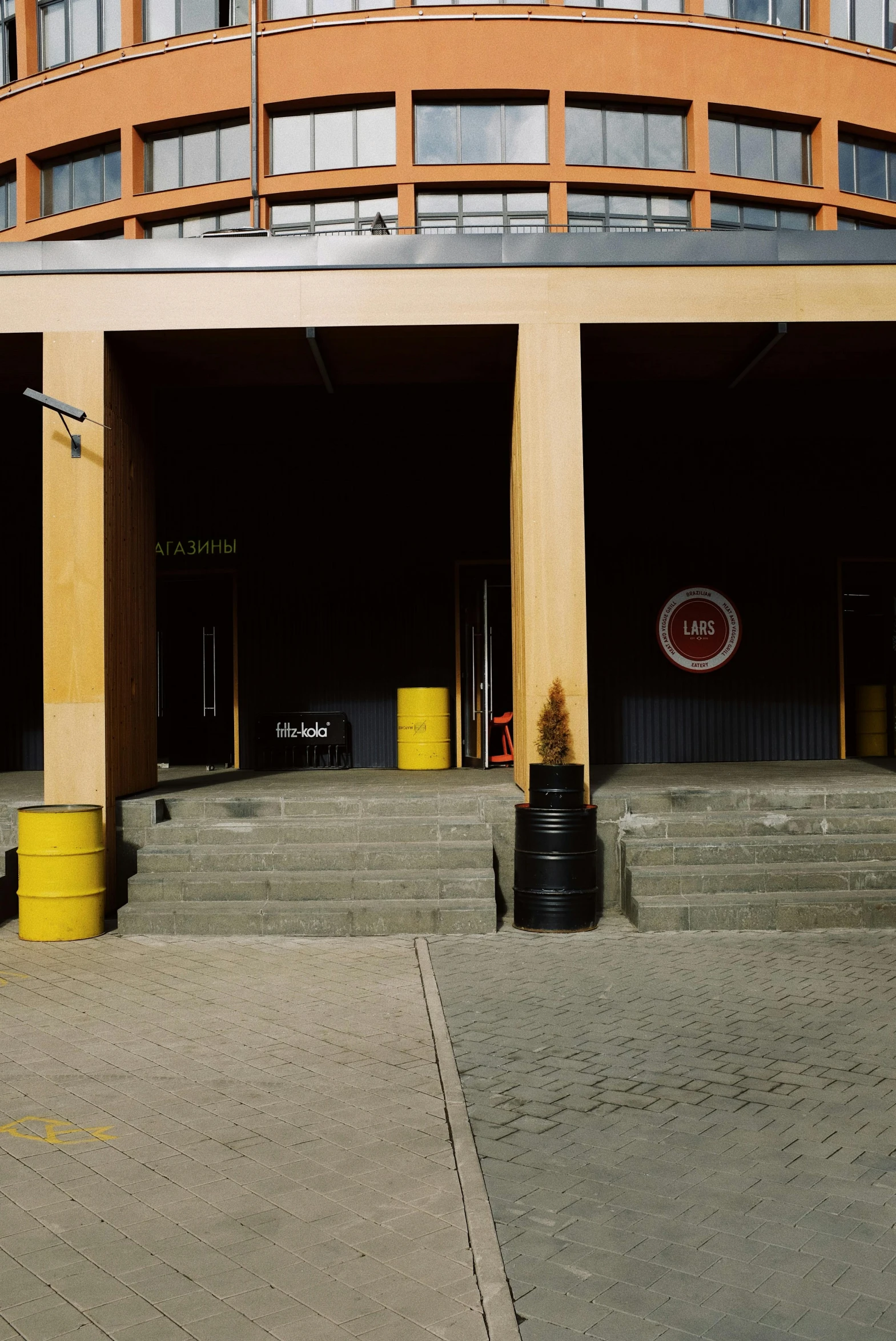 a red fire hydrant sitting in front of a building, inspired by Thomas Struth, hyperrealism, wooden crates and barrels, panoramic anamorphic, formula 1 garage, 1999 photograph