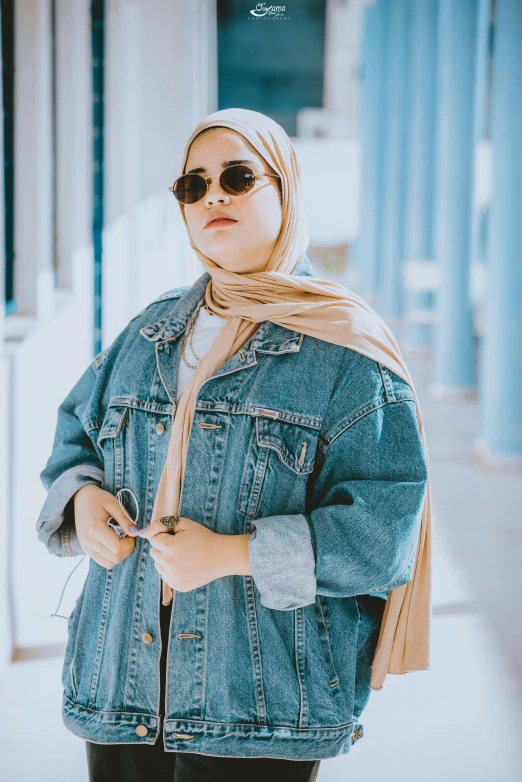 a woman wearing a hijab standing in a hallway, inspired by JoWOnder, trending on pexels, denim jacket, with sunglass, fat woman, asian women