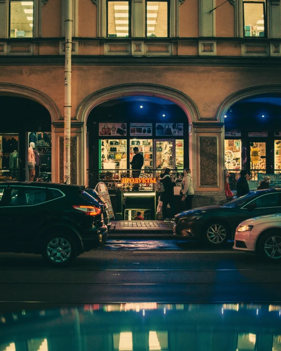 a couple of cars that are parked in front of a building, pexels contest winner, night clubs and neons, bookshops, exiting store, people in the streets