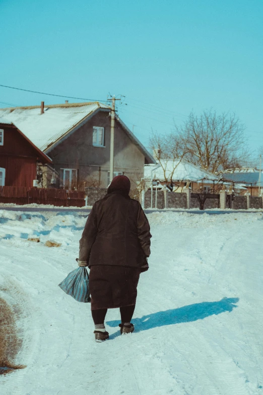 a person walking down a snow covered road, in a village, day time, russian clothes, getting groceries