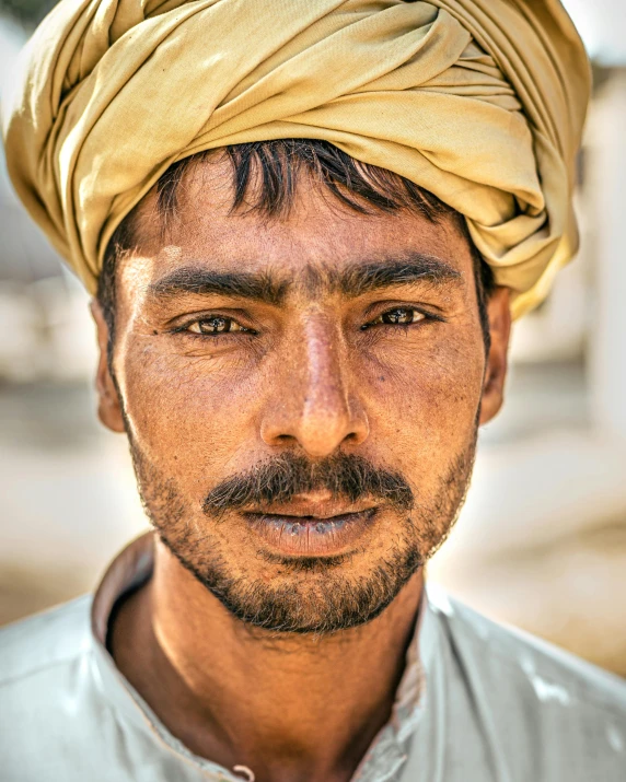 a man with a turban on his head, inspired by Steve McCurry, pexels contest winner, renaissance, lgbtq, brown stubble, square masculine facial features, farmer