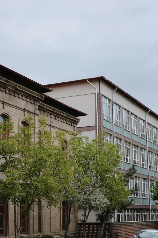 a car is parked in front of a building, a picture, unsplash, danube school, low - angle shot from behind, panoramic view, brown, paisley