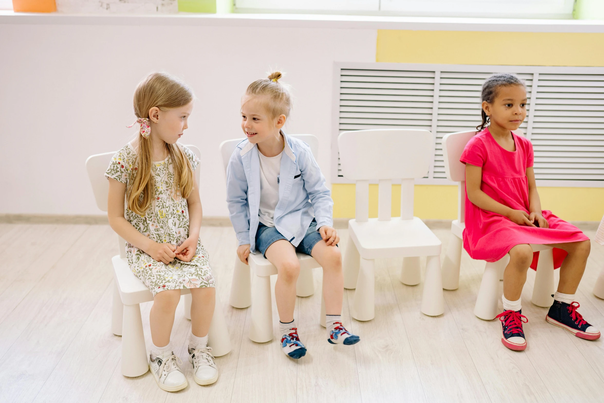 a group of children sitting on chairs in a room, on a white table, 15081959 21121991 01012000 4k, high-quality photo, mini amphitheatre
