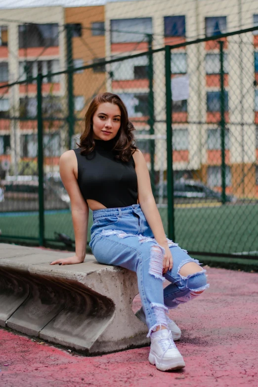 a woman sitting on top of a cement bench, by Julia Pishtar, trending on pexels, happening, ripped jeans, portrait sophie mudd, 15081959 21121991 01012000 4k, 🤤 girl portrait