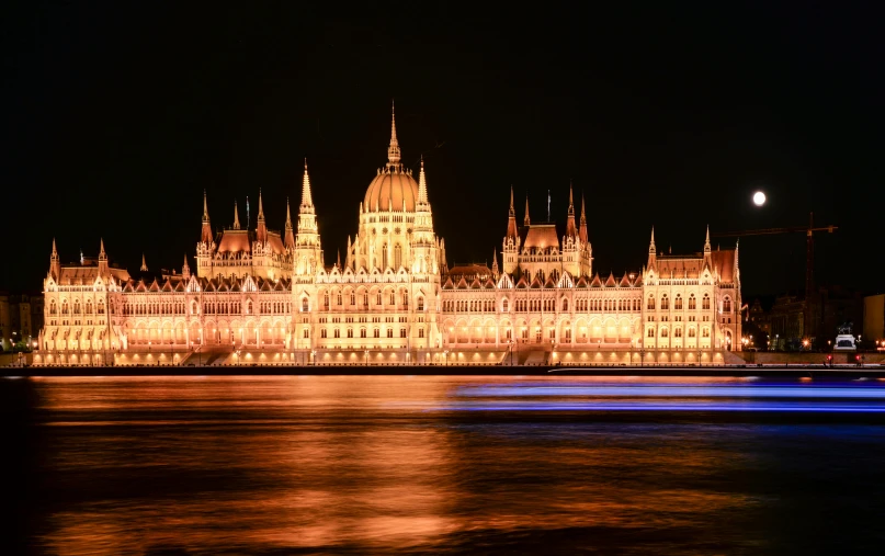 the hungarian parliament building lit up at night, a photo, pexels contest winner, baroque, thumbnail, brown, 2022 photograph, fujifilm”