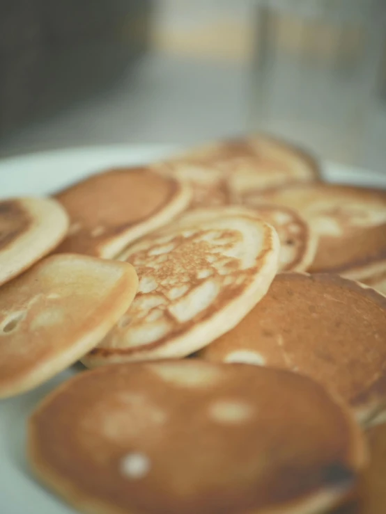 a white plate topped with lots of pancakes, a digital rendering, by Jessie Algie, unsplash, medium closeup, 5k, kek, warm shading