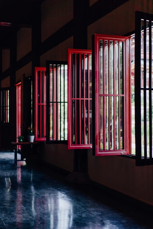 a room filled with lots of windows next to each other, inspired by Itō Jakuchū, unsplash, red, behind bars, thai architecture, seasonal