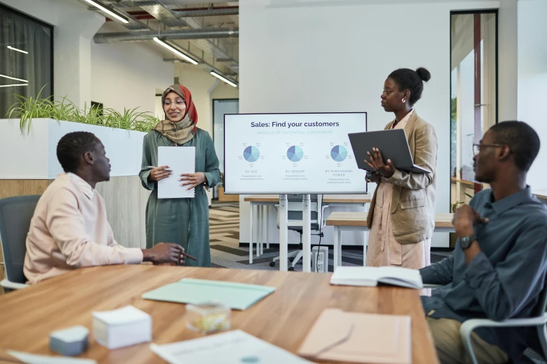 a group of people sitting around a wooden table, a cartoon, trending on unsplash, hurufiyya, giving a speech, in an office, african ameera al taweel, advertising photo