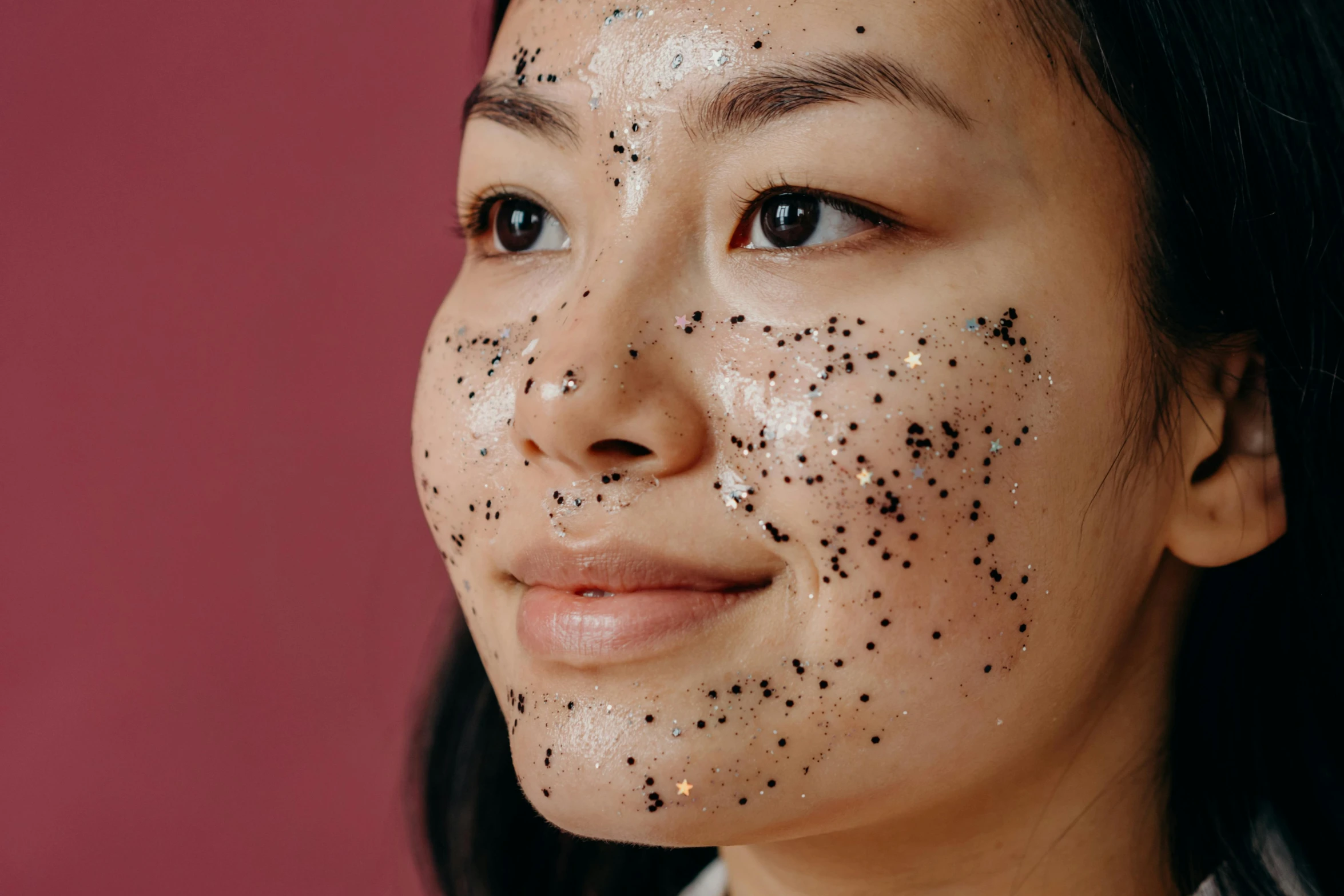 a woman with black spots on her face, a stipple, trending on pexels, mingei, set on singaporean aesthetic, made of smooth black goo, manuka, glitter gif