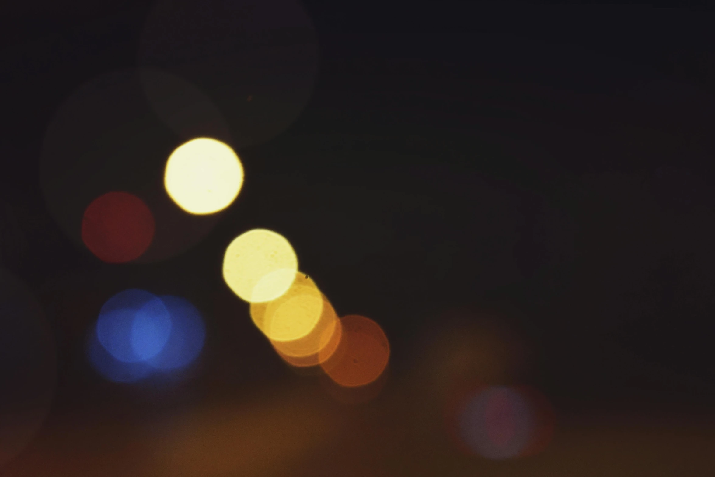 a blurry photo of a street at night, unsplash, visual art, macro bokeh ”, music video, yellow light, hazy