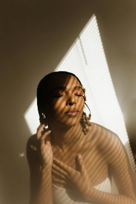 a woman that is standing in front of a window, an album cover, trending on pexels, light and space, left eye stripe, backlighted, with brown skin, portrait casting long shadows