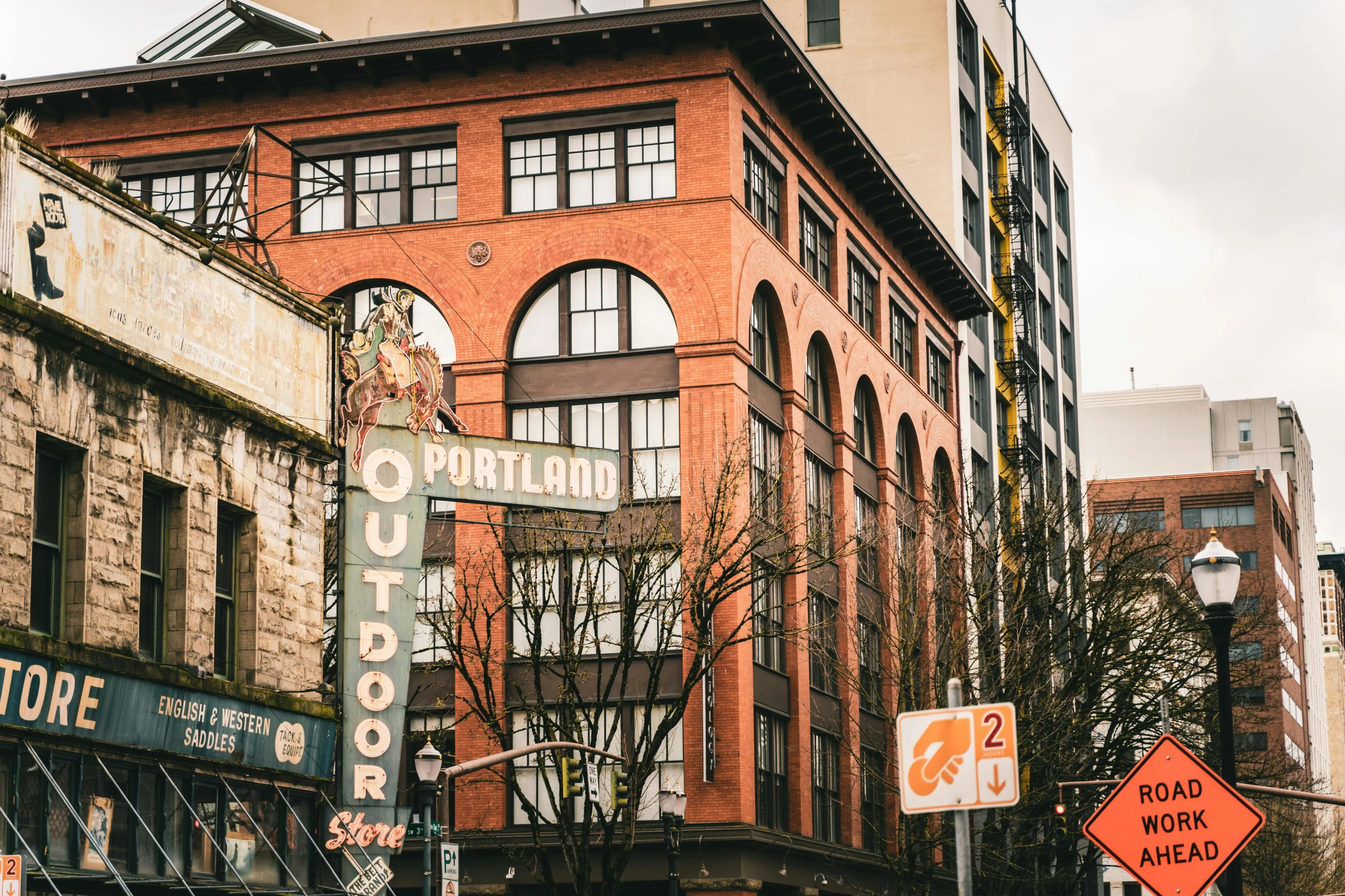 a city street filled with lots of tall buildings, a photo, by Meredith Dillman, pexels contest winner, art nouveau, ballard, old signs, brick building, 🚿🗝📝