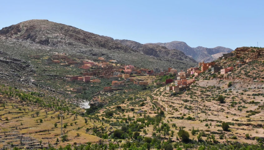 a view of a valley with mountains in the background, les nabis, mud and brick houses, slide show, fanoos, ecovillage