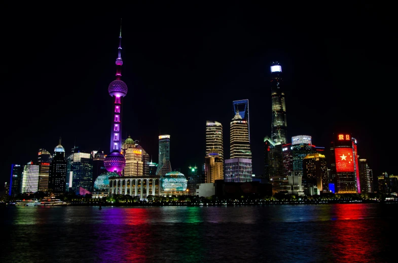 a view of a city at night from across the water, inspired by Cheng Jiasui, pexels contest winner, brightly colored, shanghai, slide show, rectangle