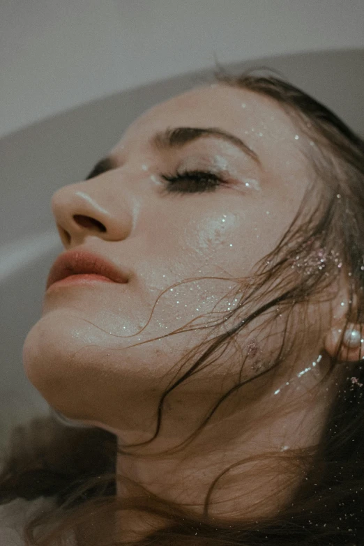 a woman taking a bath in a bathtub, inspired by Elsa Bleda, trending on pexels, hyperrealism, glitter gif, exhausted face close up, wet dripping long hair, silicone skin