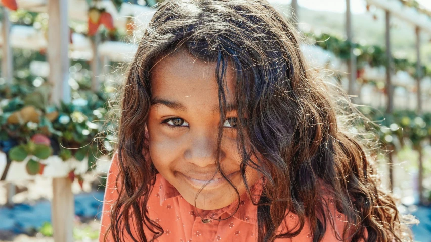 a close up of a child with long hair, pexels contest winner, hurufiyya, justina blakeney, very happy, olive skin color, uncropped