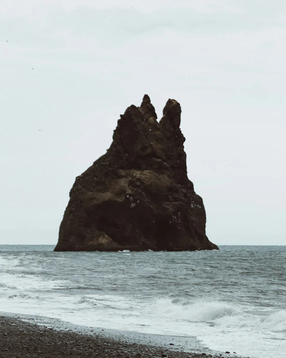 a man standing on top of a beach next to the ocean, devil's horns, on a gray background, viewed from the ocean, stacked image