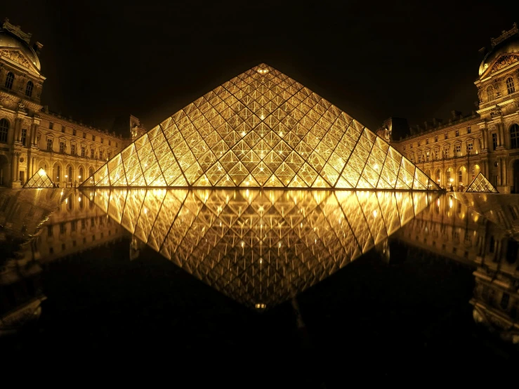 the glass pyramid is lit up at night, pexels contest winner, op art, palace of the chalice, mirrored, golden glistening, boucheron
