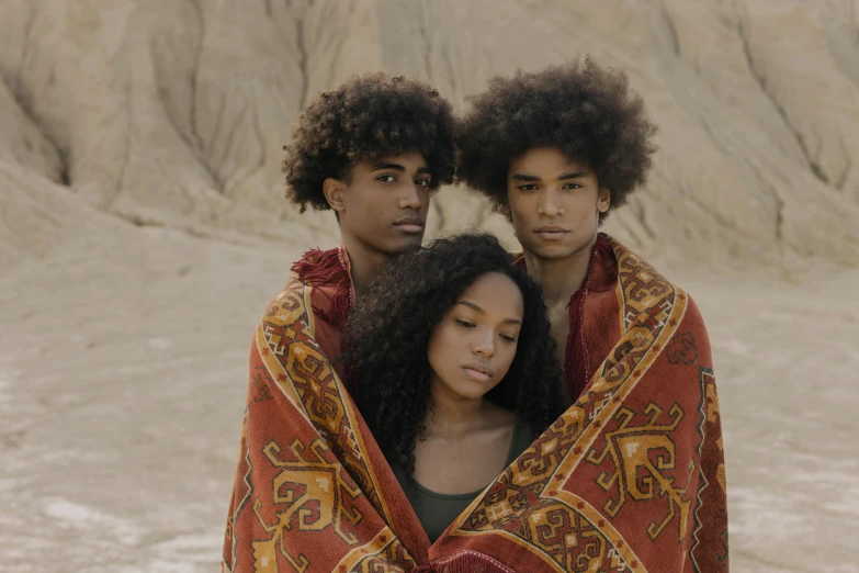 a man and a woman wrapped in a blanket, pexels contest winner, afrofuturism, three futuristic princes, siblings, brown curly hair, ( ( theatrical ) )