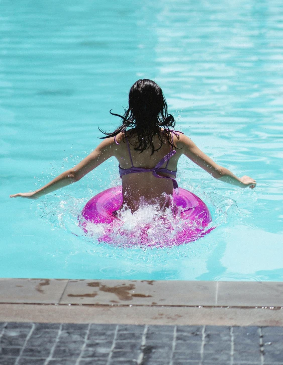 a woman in a bikini swims in a pool, pexels contest winner, rainbow tubing, thumbnail, hoverboards, low quality photo