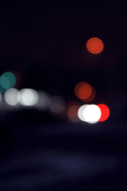 a blurry photo of a city street at night, pexels, minimalism, overcast bokeh - c 5, police car lights, reds, an abstract