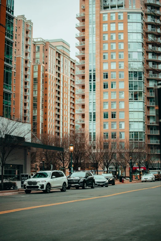 a city street filled with lots of tall buildings, a picture, inspired by Washington Allston, unsplash contest winner, renaissance, parked cars, 8k 50mm iso 10, square, washington dc