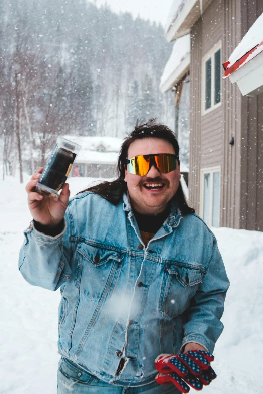 a man holding up a can of beer in the snow, an album cover, trending on reddit, mustache and soul patch, vacation photo, post malone, andy milonakis