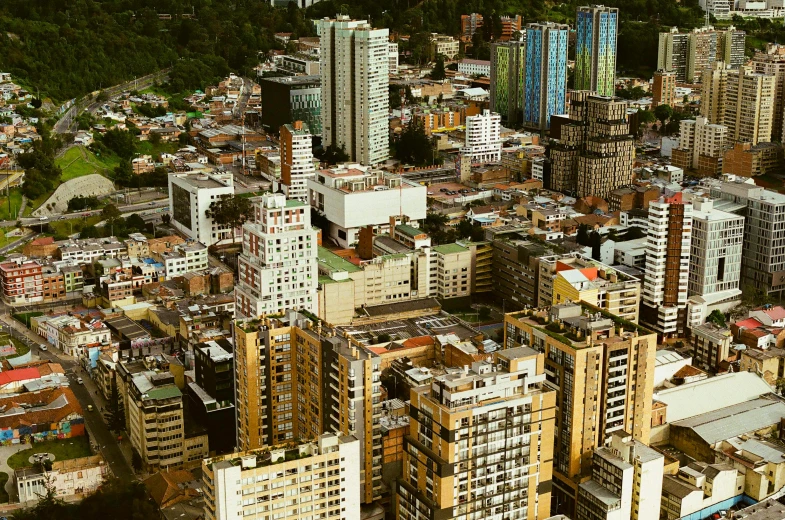 a city filled with lots of tall buildings, inspired by Thomas Struth, pexels contest winner, quito school, square, brown, a green, aerial