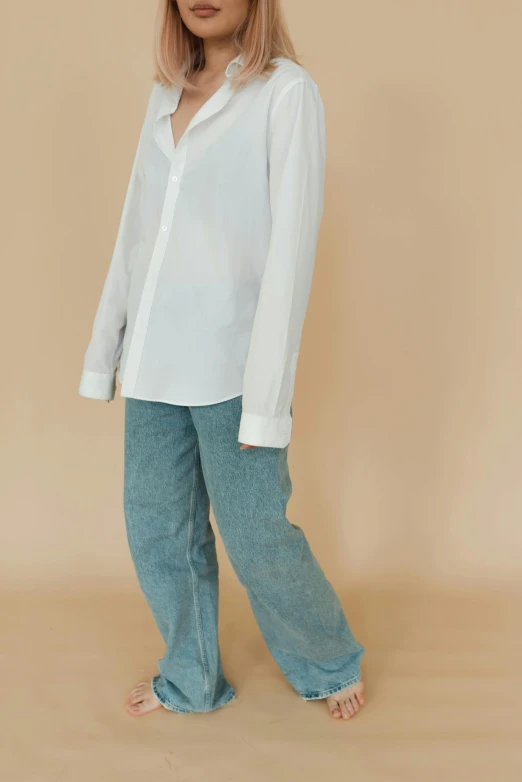 a woman wearing a white shirt and blue pants, by Nina Hamnett, corduroy, zoomed out full body, white poet shirt, full product shot