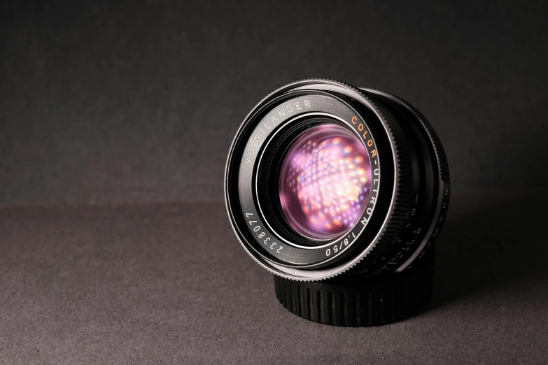 a close up of a camera lens on a table, pexels contest winner, photorealism, spectular lighting, medium format. soft light, rolleiflex, 3 5 mm!!!!! lens