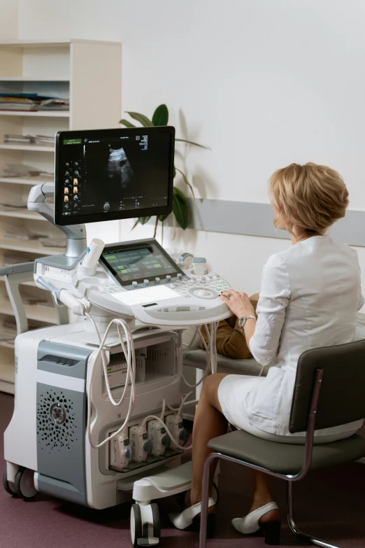a woman sitting in a chair in front of a computer, digital medical equipment, neo kyiv, system unit, green