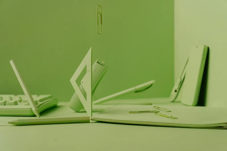 a laptop computer sitting on top of a desk, by jeonseok lee, featured on behance, conceptual art, paper cutouts of plain colors, green and white, made of paperclips, green tint