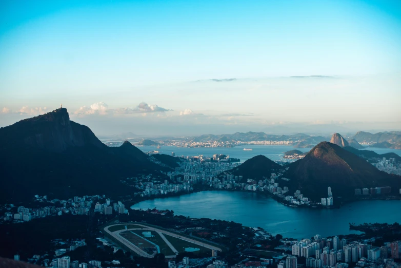 a view of a city from the top of a mountain, by Elsa Bleda, pexels contest winner, oscar niemeyer, wide river and lake, slide show, monumental mountains