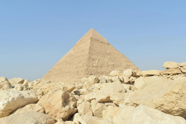 a large pile of rocks in front of a pyramid, egyptian art, pexels contest winner, hurufiyya, avatar image, view from ground, ultra high res, side - view