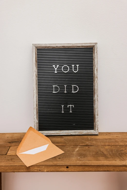 a letter board sitting on top of a wooden table, by Bernie D’Andrea, unsplash contest winner, 'he knows what you did ', dug stanat, decorations, upcycled