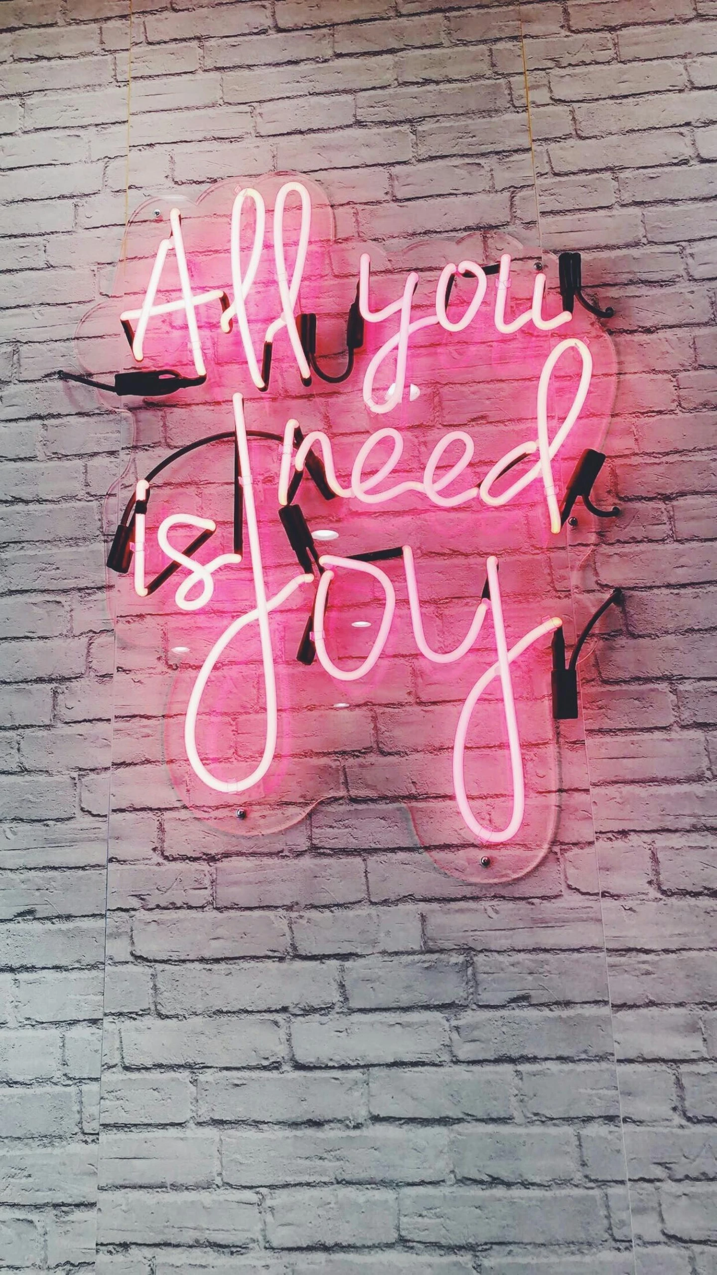 a neon sign that says all you need is joy, pexels, 🎀 🍓 🧚, low quality photo, instagram photo, concept photo