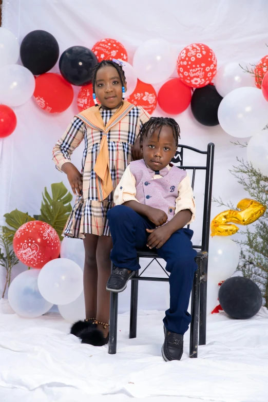 a couple of kids sitting on top of a chair, by Chinwe Chukwuogo-Roy, pexels, visual art, at a birthday party, 15081959 21121991 01012000 4k, in front of white back drop, holiday season