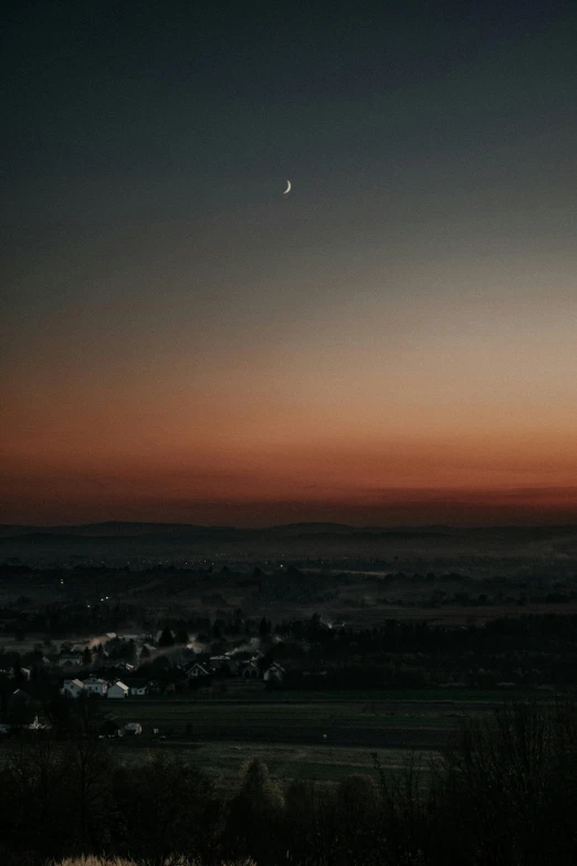 a couple of sheep standing on top of a lush green field, by Sebastian Spreng, unsplash contest winner, romanticism, city sunset night, crescent moon, distant town in valley and hills, germany. wide shot