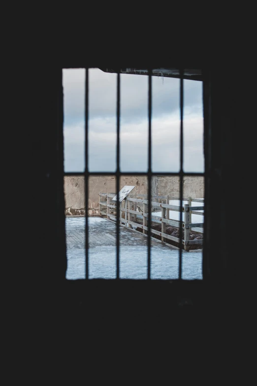 a window with a view of a body of water, inspired by Elsa Bleda, unsplash, prison bars, ice gate, low quality photo, fortress