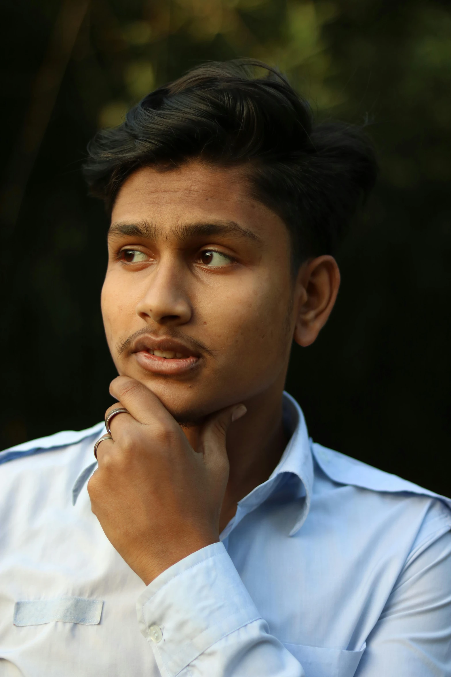 a close up of a person wearing a shirt, inspired by Bikash Bhattacharjee, trending on reddit, realism, pensive expression, male teenager, professional photo, lgbtq