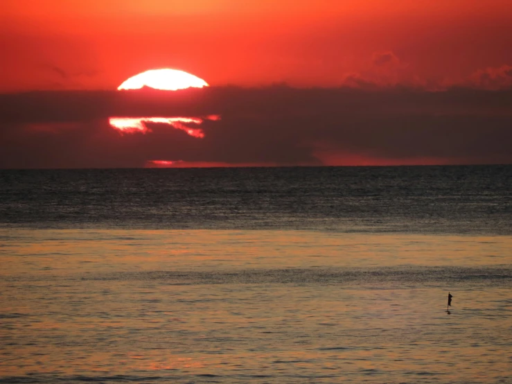 the sun is setting on the horizon of the ocean, a photo, pexels contest winner, romanticism, red sun over paradise, jamaica, slide show, minimalist