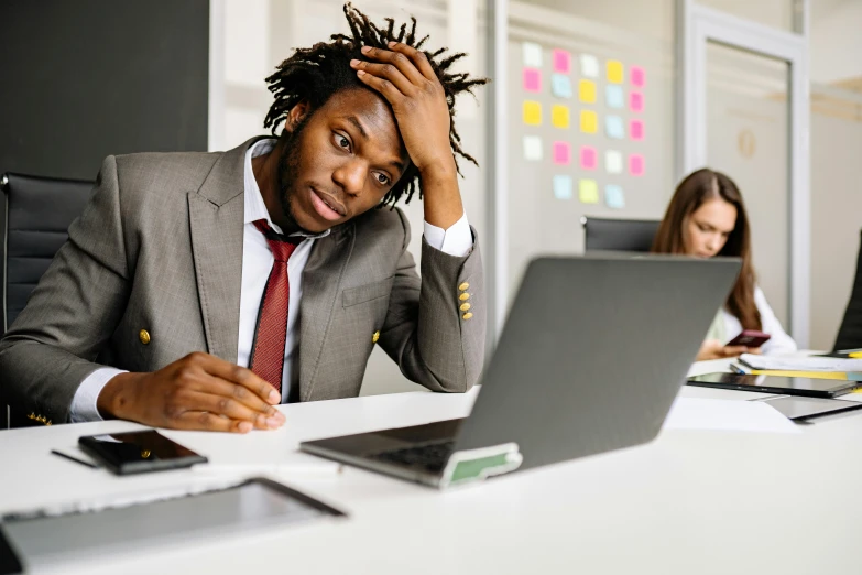 a man sitting at a desk in front of a laptop computer, trending on pexels, renaissance, two exhausted, black people, professional picture, a person standing in front of a