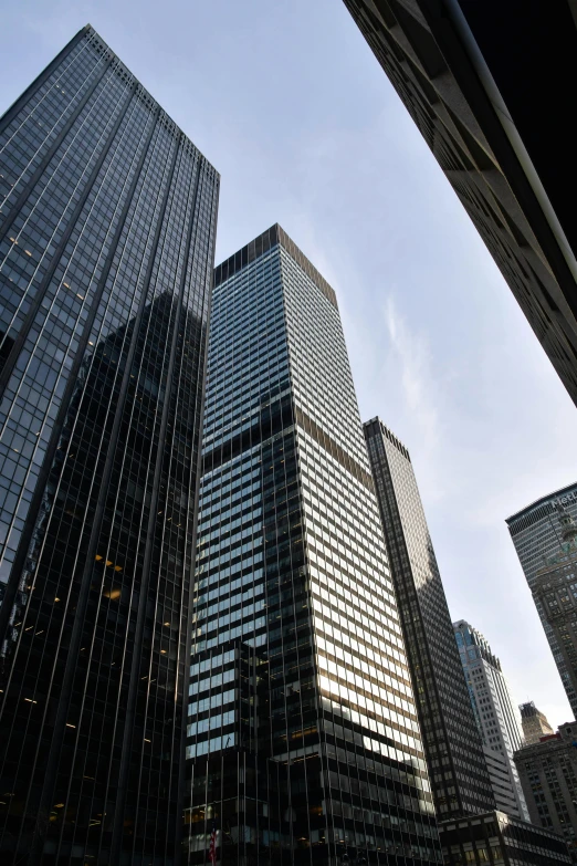 some very tall buildings in a big city, a picture, by Dan Scott, flickr, mies van der rohe, wall street, wikimedia, serious business